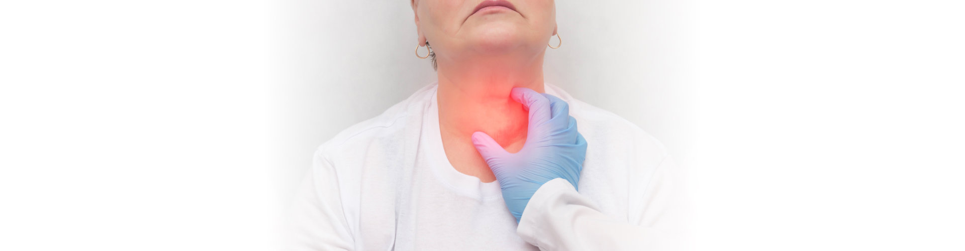 doctor touching the thyroid gland of a patient