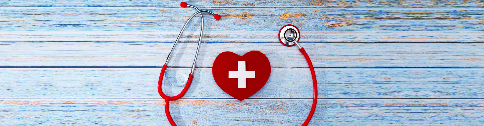 red stethoscope with a heart shaped figure