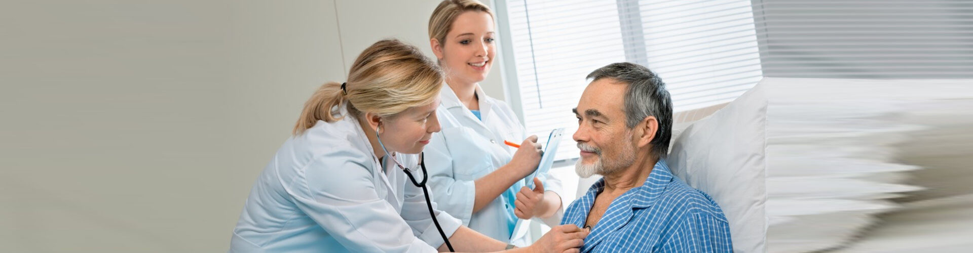 nurses checking senior man